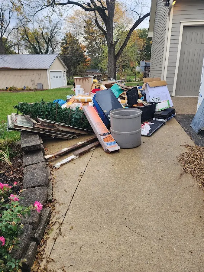 Dumpster being loaded with debris for 12 Yard Dumpster Rental in West Reading